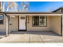 Inviting front porch with updated door and stone flooring at 990 Hazel Ct, Denver, CO 80204