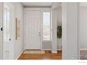 Bright entryway with hardwood floors and neutral walls at 10054 Telluride St, Commerce City, CO 80022