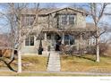 Two-story house with a front porch and landscaping at 10054 Telluride St, Commerce City, CO 80022