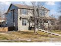 Two-story house with landscaping, and a walkway at 10054 Telluride St, Commerce City, CO 80022