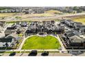 An aerial view of modern homes surrounding a landscaped green space within a well-planned community at 129 Mesa Way, Superior, CO 80027