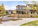 Inviting home featuring a charming front porch with white rocking chairs and a tidy yard at 129 Mesa Way, Superior, CO 80027