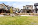 Beautifully landscaped front yard with green grass and a sidewalk leading to the homes at 129 Mesa Way, Superior, CO 80027