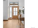 Light and bright entryway with wood floors and a stylish console table at 1422 Eliza Ave, Berthoud, CO 80513