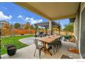 Patio with wooden dining table and seating at 16060 E Fairway Dr, Commerce City, CO 80022