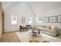 Modern living room featuring exposed brick, vaulted ceilings, and ample natural light at 2130 22Nd St, Boulder, CO 80302