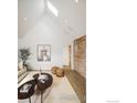 Open living area with exposed brick wall, vaulted ceilings, and a cozy seating area at 2130 22Nd St, Boulder, CO 80302