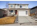 Two-story house with a white garage door and landscaping at 21837 E Stanford Cir, Aurora, CO 80015
