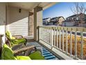 Relaxing front porch with wicker chairs and view of the neighborhood at 21837 E Stanford Cir, Aurora, CO 80015