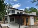 Contemporary home with black trim windows, stucco, light-wood accents, and a spiral staircase at 2250 Bluebell Ave, Boulder, CO 80302