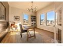 Bright home office featuring built-in shelving and large windows at 2294 Stonebrae Ct, Berthoud, CO 80513