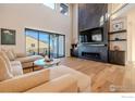 Spacious living room with a floor to ceiling fireplace and large windows at 2294 Stonebrae Ct, Berthoud, CO 80513