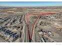 Aerial view showing a large lot of land near a highway and residential area at 2550 175Th Ave, Erie, CO 80516