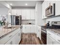 White shaker cabinets, granite countertops, and stainless steel appliances at 2736 Cooperland Blvd, Berthoud, CO 80513