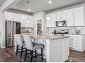 Kitchen with granite island, white cabinets, and stainless steel appliances at 2736 Cooperland Blvd, Berthoud, CO 80513