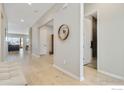 Bright hallway with light wood floors and access to living room and bathroom at 3351 Heron Lakes Pkwy, Berthoud, CO 80513