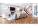 Spacious living room featuring hardwood floors, a fireplace, and a modern staircase at 3681 Paonia St, Boulder, CO 80301