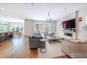 Open living space with hardwood floors, fireplace, and kitchen view at 3681 Paonia St, Boulder, CO 80301