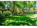 Back exterior view of charming wood house with large yard at 3776 Orange Ln, Boulder, CO 80304