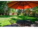 Outdoor patio area with table, chairs, and umbrella at 3776 Orange Ln, Boulder, CO 80304