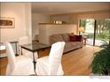 Bright living room with hardwood floors, dining area, and access to a patio at 3805 Northbrook Dr # A, Boulder, CO 80304