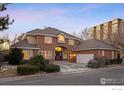 Two-story brick home with a two-car garage at dusk at 400 S Steele St # 63, Denver, CO 80209