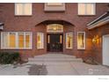 Elegant entryway with a dark wood door and brick accents at 400 S Steele St # 63, Denver, CO 80209