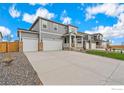 Two-story house with gray siding, two-car garage, and front porch at 4207 Sandstone Dr, Mead, CO 80504