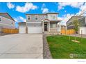 Two-story house with gray siding, two-car garage, and front porch at 4207 Sandstone Dr, Mead, CO 80504