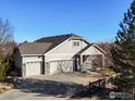 Ranch style home with three-car garage and a long driveway at 4355 W 107Th Dr, Westminster, CO 80031