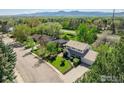 Charming two-story home with a well-maintained lawn, mature trees, and mountain views at 4667 Ashfield Dr, Boulder, CO 80301