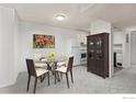 Cozy dining area with glass table and kitchen access at 5110 Williams Fork Trl # 203, Boulder, CO 80301