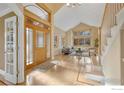 Bright and spacious entryway with hardwood floors and a view of the living room at 6345 Swallow Ln, Boulder, CO 80303