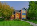 Charming home with a brick facade, manicured lawn, and mature trees offers great curb appeal at 6345 Swallow Ln, Boulder, CO 80303