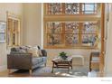 Living room with large windows, hardwood floors, and comfortable seating at 6345 Swallow Ln, Boulder, CO 80303