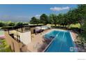 Community pool with lounge area and cabana at 6345 Swallow Ln, Boulder, CO 80303
