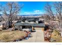 An aerial view of a house with a large yard and mountain views at 7913 Grasmere Dr, Boulder, CO 80301