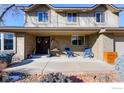 Inviting front porch with brick columns, blue chairs, and a wooden box at 7913 Grasmere Dr, Boulder, CO 80301