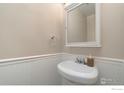 Clean bathroom with pedestal sink and mirror at 8778 Mariposa St, Thornton, CO 80260