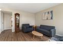 Living room featuring wood floors and ample seating at 8778 Mariposa St, Thornton, CO 80260