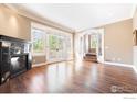 Spacious living room featuring hardwood floors, a fireplace, and access to a deck at 1521 Mapleton Ave, Boulder, CO 80304