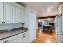 Modern kitchen with granite counters open to dining and living areas at 246 S 22Nd Ave, Brighton, CO 80601