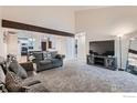 Bright living room features vaulted ceilings and views into dining and kitchen areas at 246 S 22Nd Ave, Brighton, CO 80601