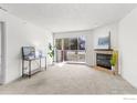 Bright living room with a fireplace, sliding glass doors to the patio, and neutral carpet at 4840 Twin Lakes Rd # 7, Boulder, CO 80301