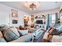 Spacious living room featuring comfortable seating, a large TV, and decorative accents at 6004 Sandstone Cir, Erie, CO 80516