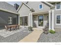 Inviting front porch with rocking chairs and an outdoor dining area at 7401 Deerfield Rd, Longmont, CO 80503