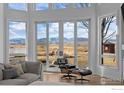 Living room with large windows showcasing scenic mountain views at 7401 Deerfield Rd, Longmont, CO 80503