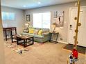 Bright living room with a light teal sofa and entryway at 7779 Pecos St, Denver, CO 80221