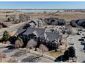 Aerial view showing the condo building, parking area, and a beautiful view of a lake at 804 Summer Hawk Dr # 1303, Longmont, CO 80504