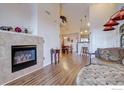 Open-concept living room with fireplace, high ceilings and a view into the kitchen at 804 Summer Hawk Dr # 1303, Longmont, CO 80504